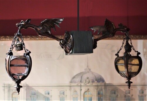 Pair of wall lights in the shape of a dragon holding a lantarn.