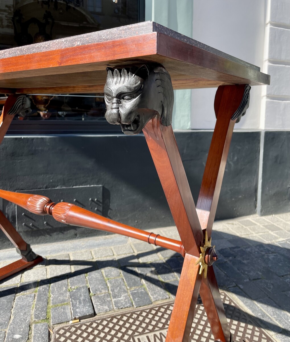 Directory style table decorated with lion heads.