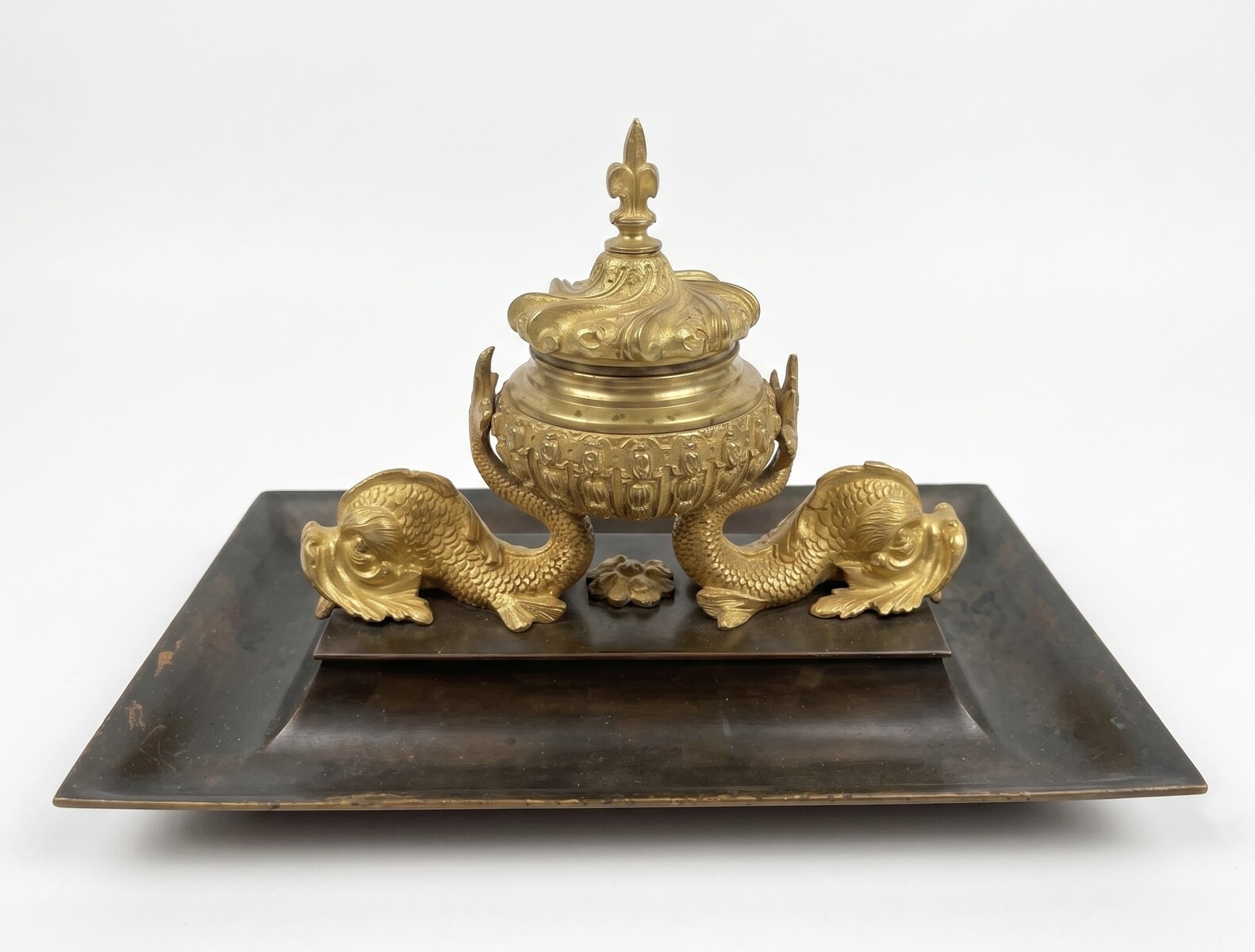 inkwell decorated with dolphins and a lily flower