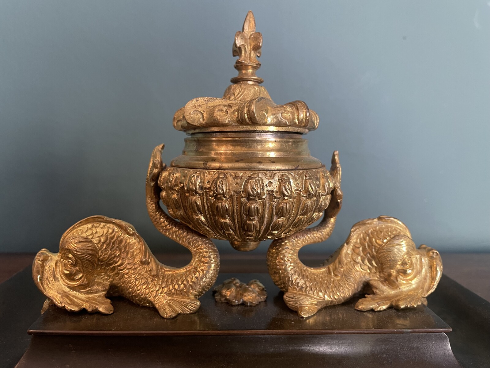 inkwell decorated with dolphins and a lily flower