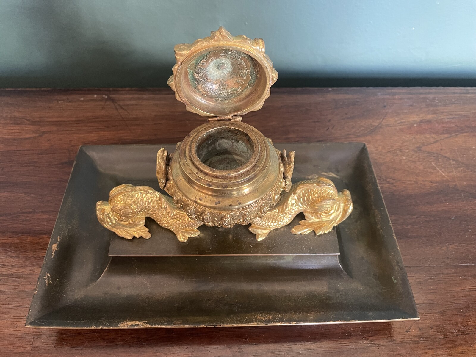 inkwell decorated with dolphins and a lily flower