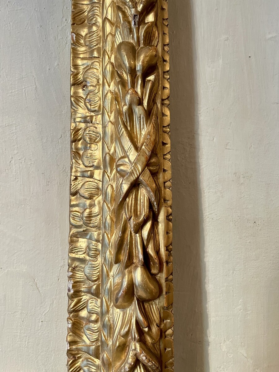 Louis XIV style frame decorated with wreaths of foliage and fruit