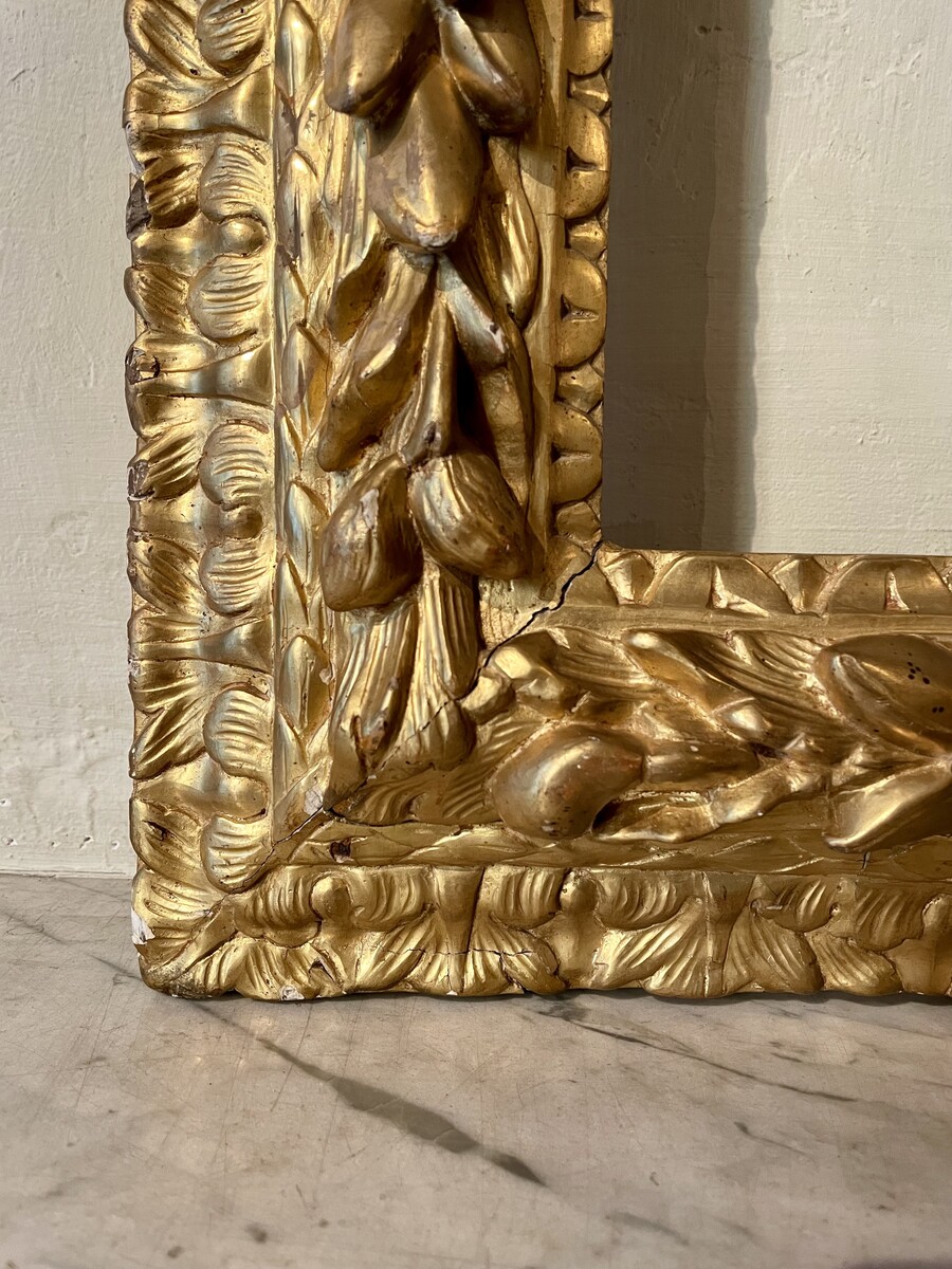 Louis XIV style frame decorated with wreaths of foliage and fruit
