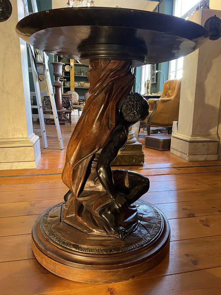 Moor-shaped gueridon supporting a carved circuar top