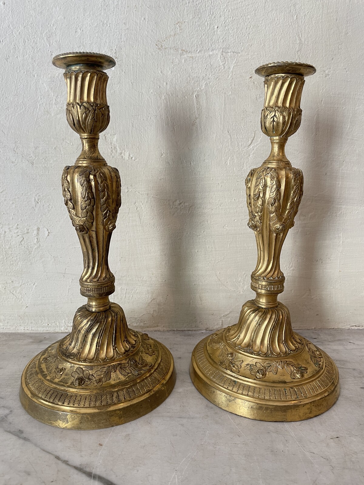 Pair of Louis XVI candlesticks with floral decoration.