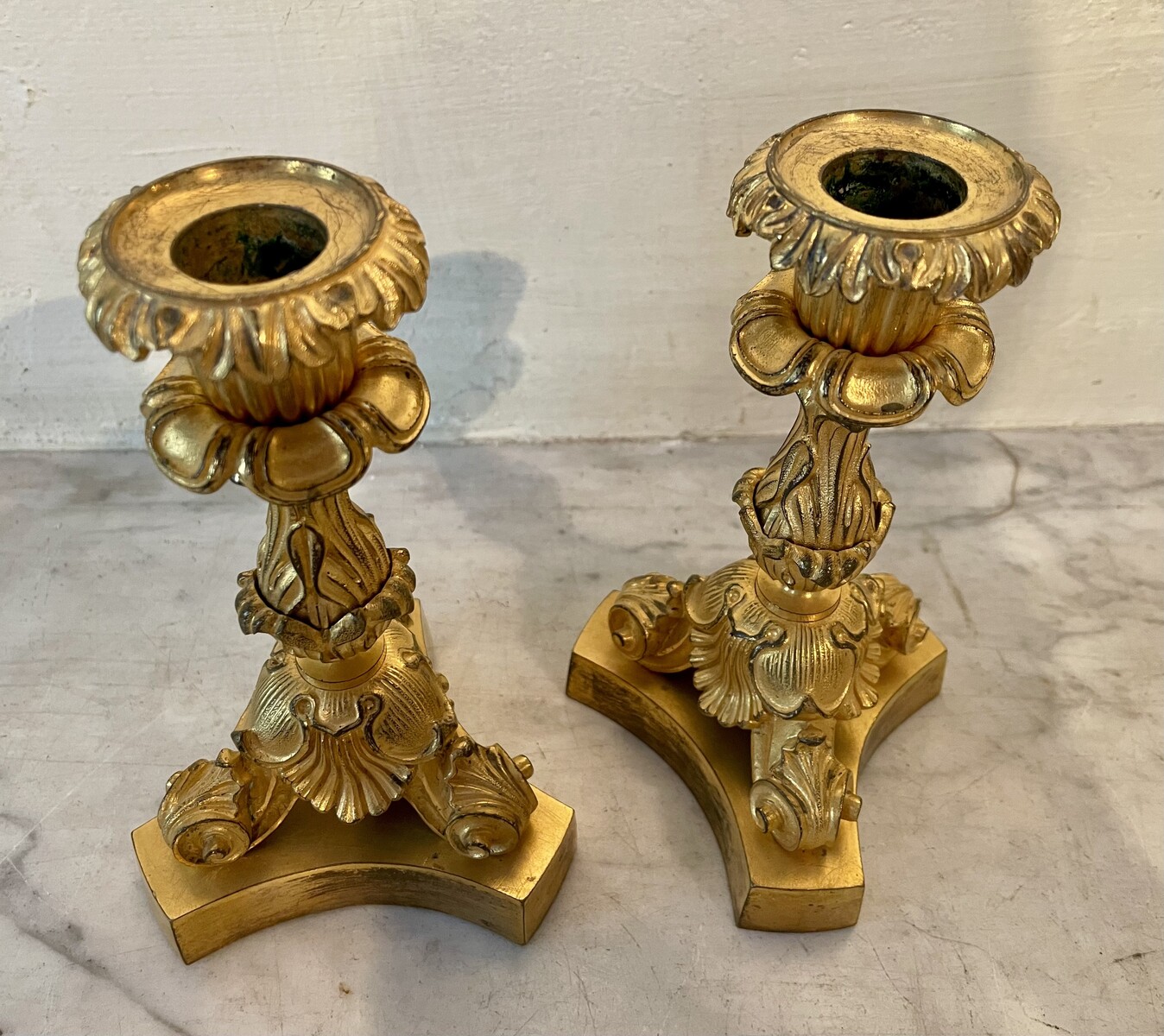 Pair of small candlesticks with vegetal and shell decoration