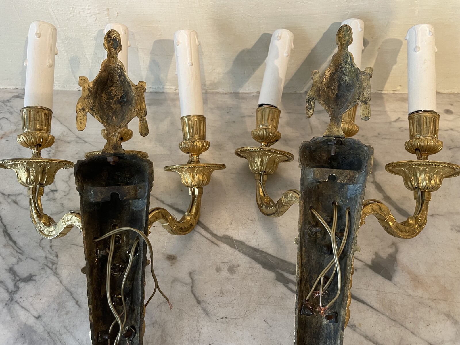 Pair of three-lights sconces in Louis XVI style