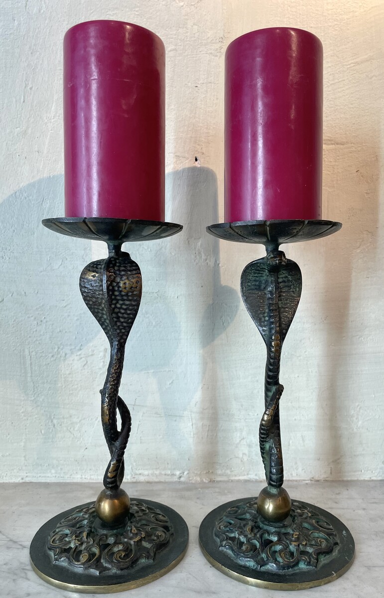 Small candle sticks in the shape of a snake. Openwork base with arabesque decoration