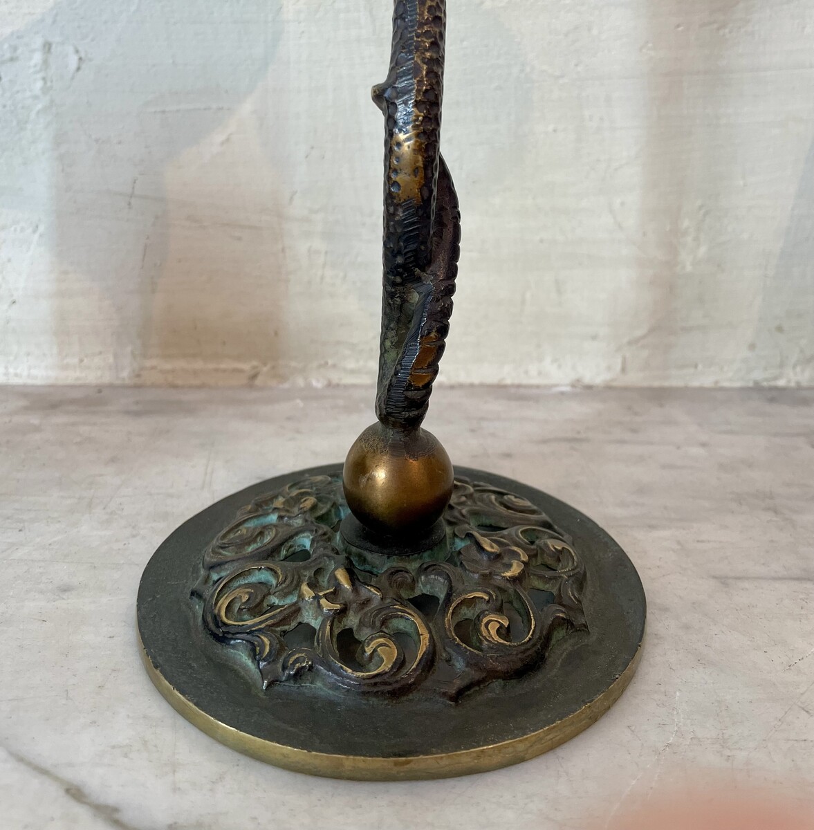 Small candle sticks in the shape of a snake. Openwork base with arabesque decoration