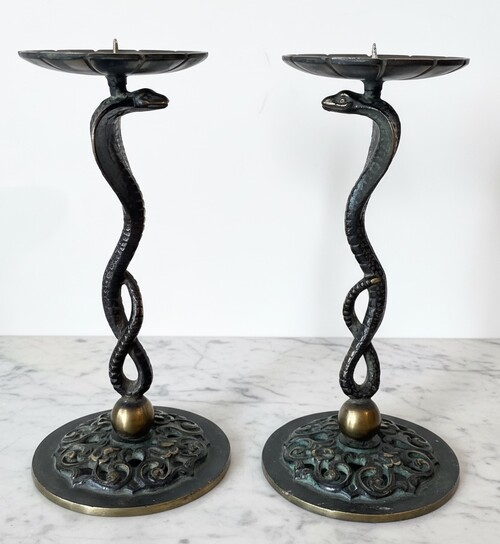 Small candle sticks in the shape of a snake. Openwork base with arabesque decoration