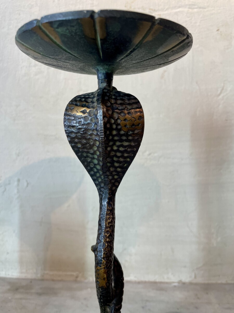 Small candle sticks in the shape of a snake. Openwork base with arabesque decoration